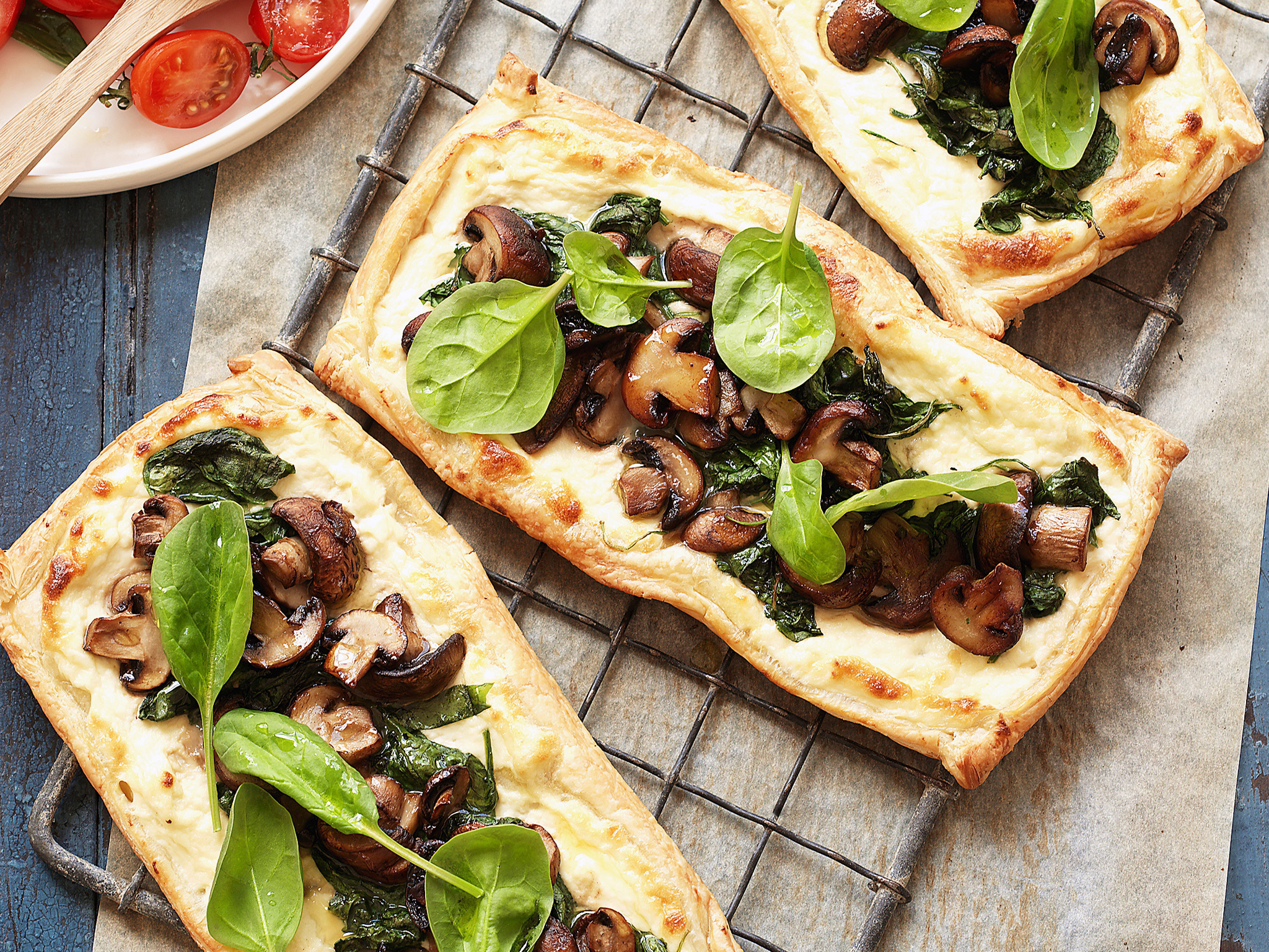 Mushroom and spinach tarts with tomato salad