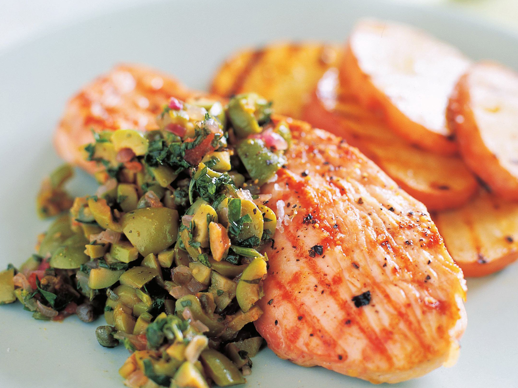 Grilled turkey steaks with green olive and tomato relish