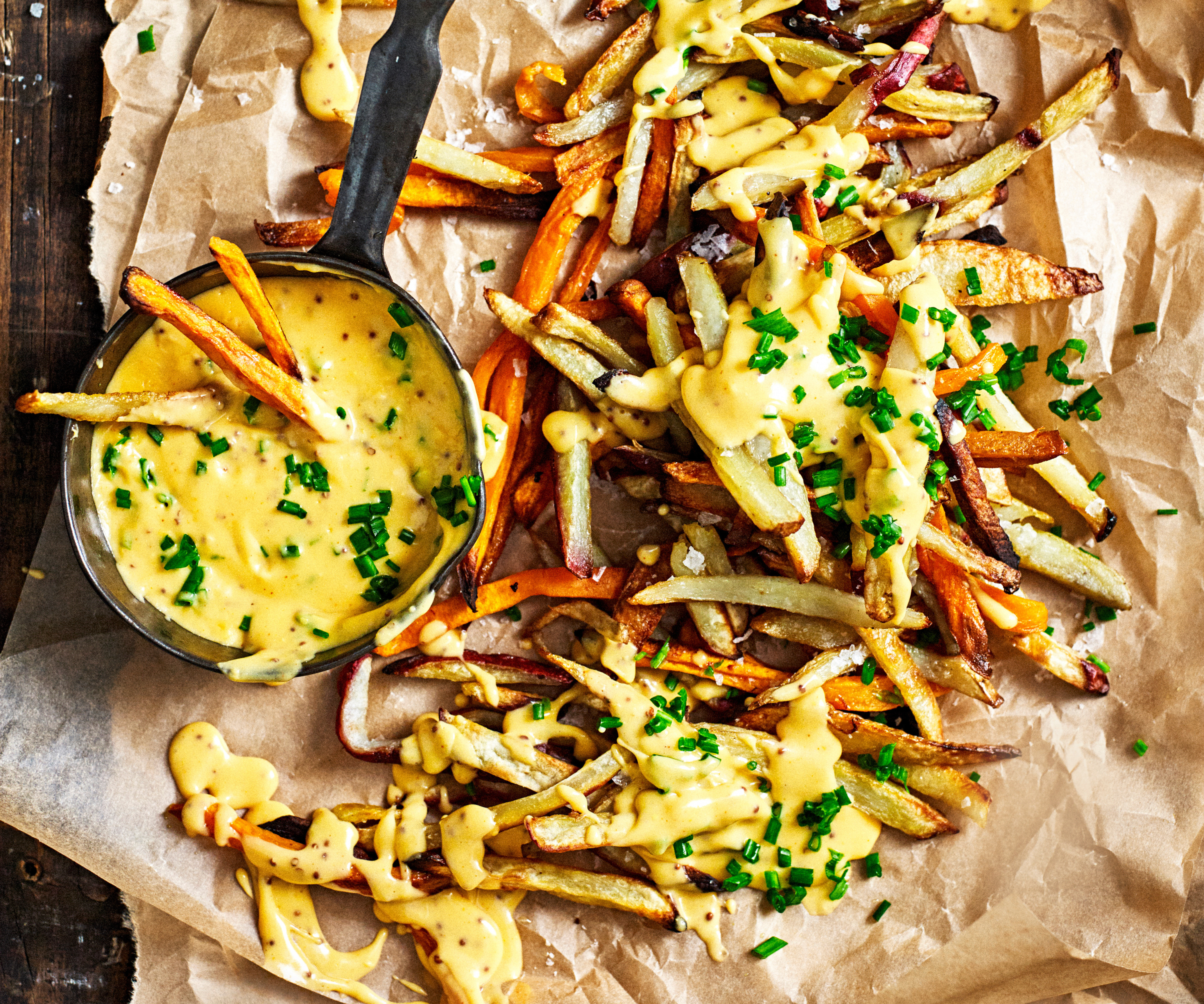 Loaded root fries with beer & mustard sauce on top.