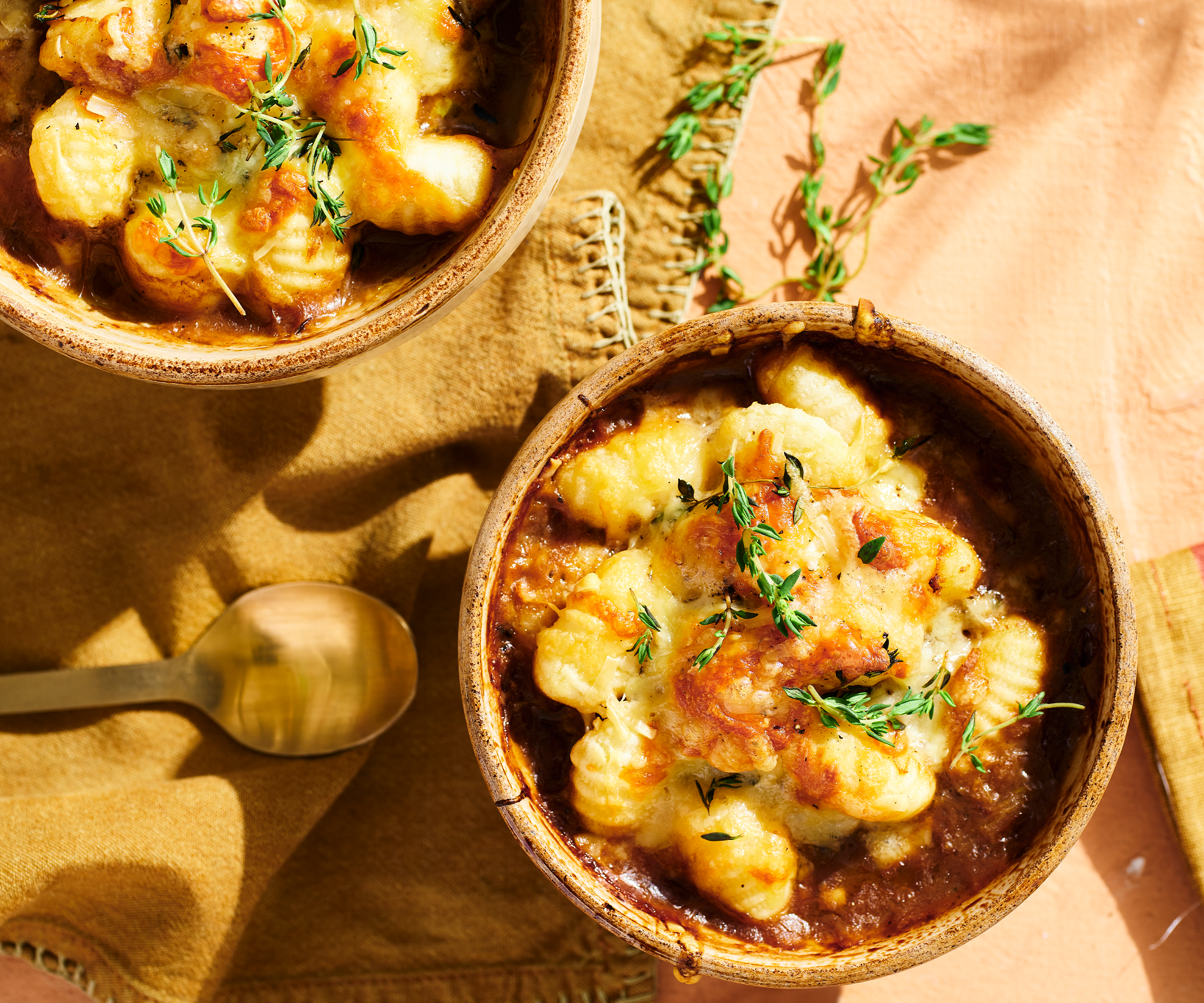 Bowls of cheesy gnocchi French onion soup