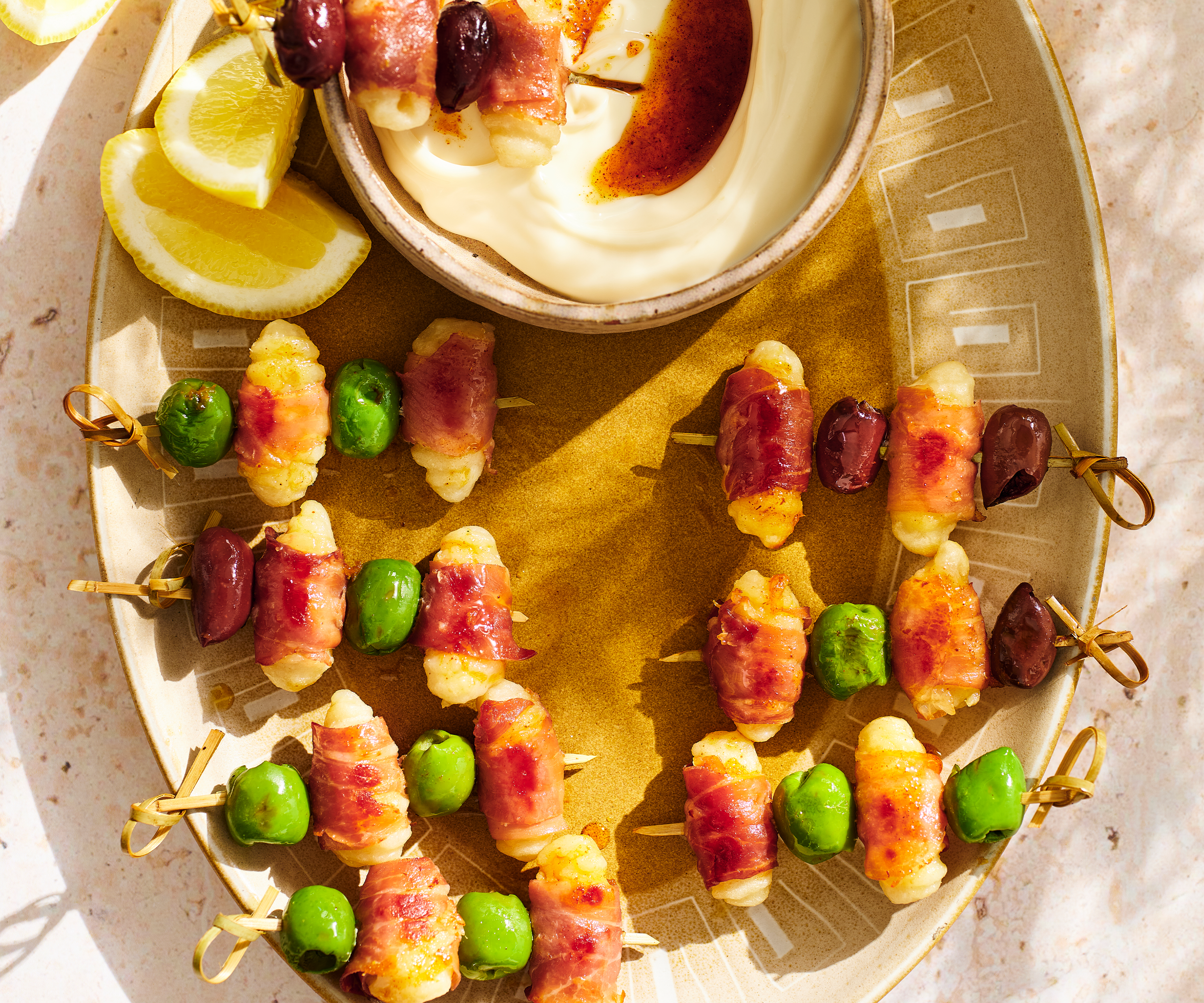 A plate of smoky gnocchi & prosciutto skewers