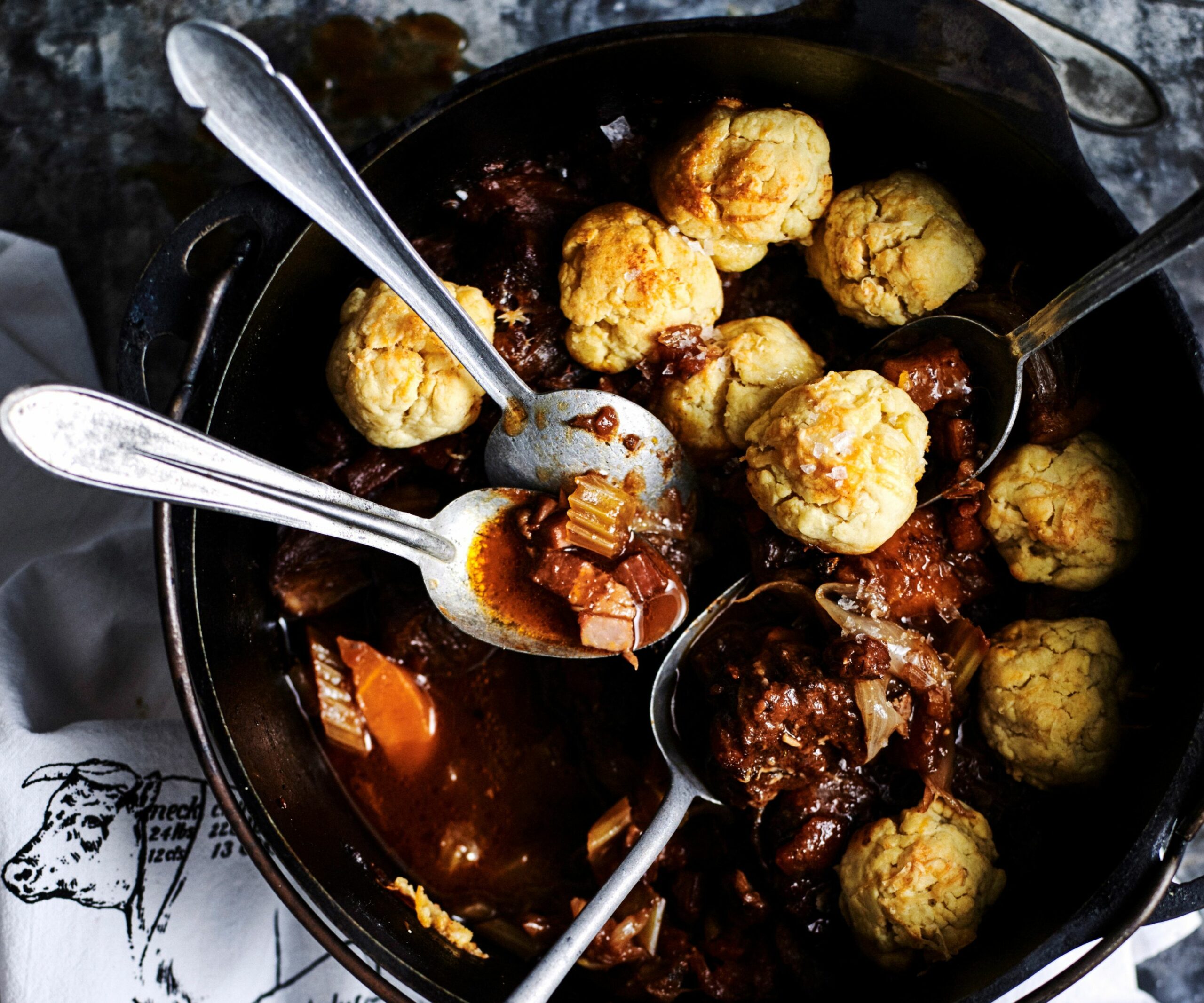 pot of red wine stew topped with dumplings