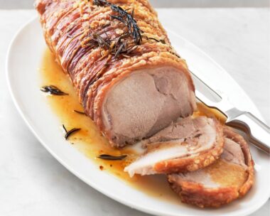 Pork loin roast with crackling on a platter