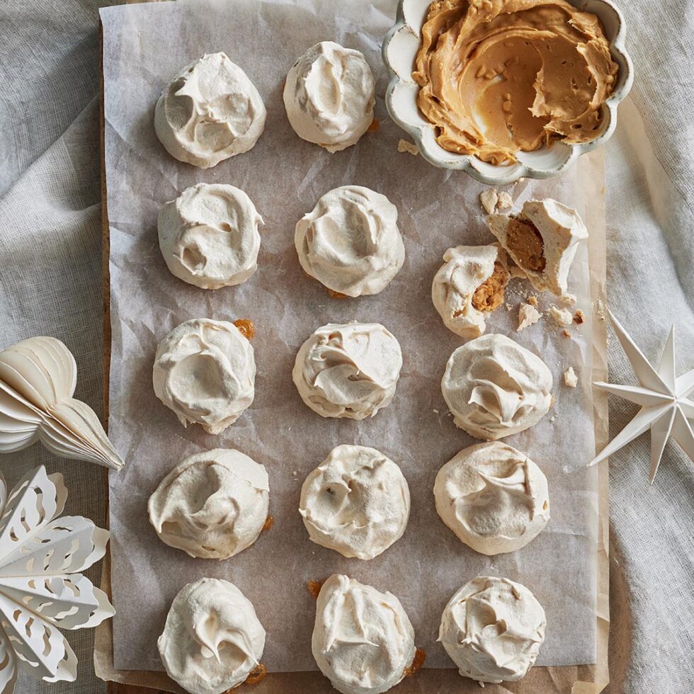 Peanut butter filled mini meringues on a cooling rack