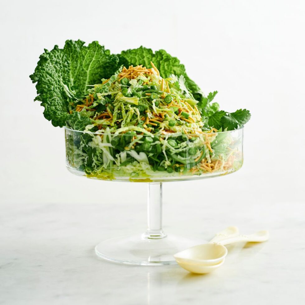 Fresh coleslaw with crispy noodles served in a footed glass bowl.