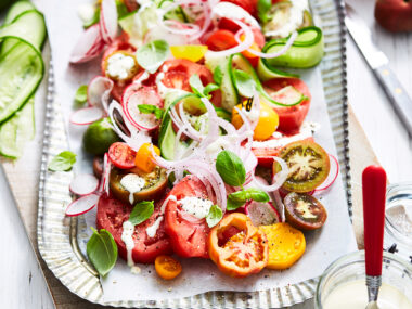 Summer tomato salad with creamed fetta on a platter