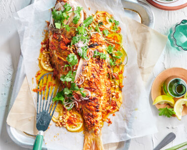 Whole baked fish with tahini, pickled shallot and fresh herbs