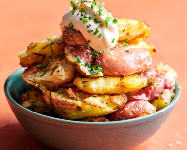 A bowl filled with crispy roast potatoes.